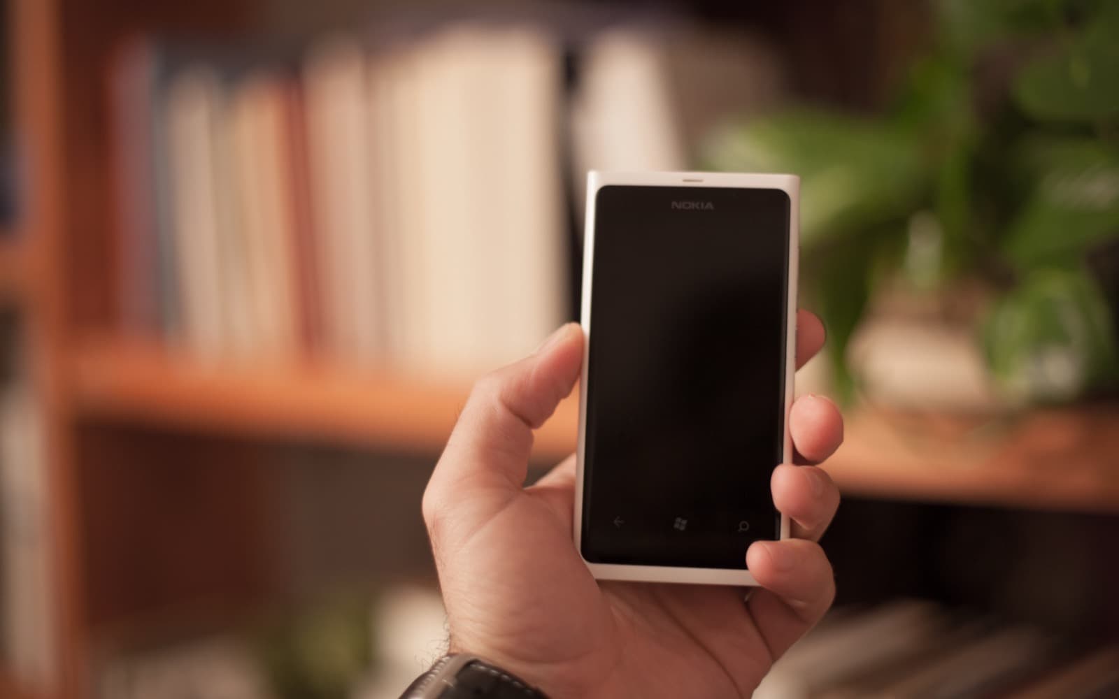 A consumer using a smartphone — telecoms, FMCG and electronics reach
