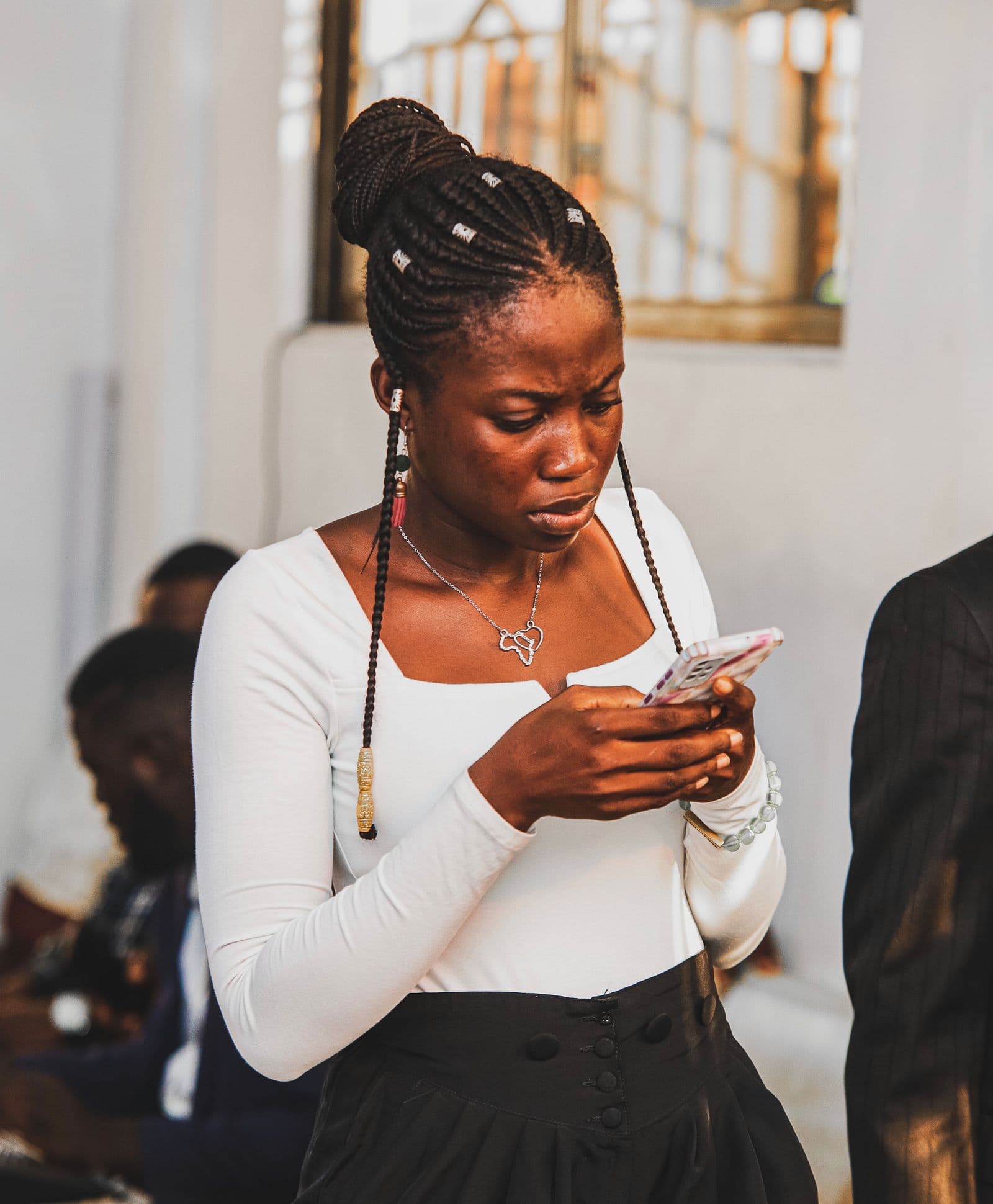 A young woman in Accra signing up on her smartphone