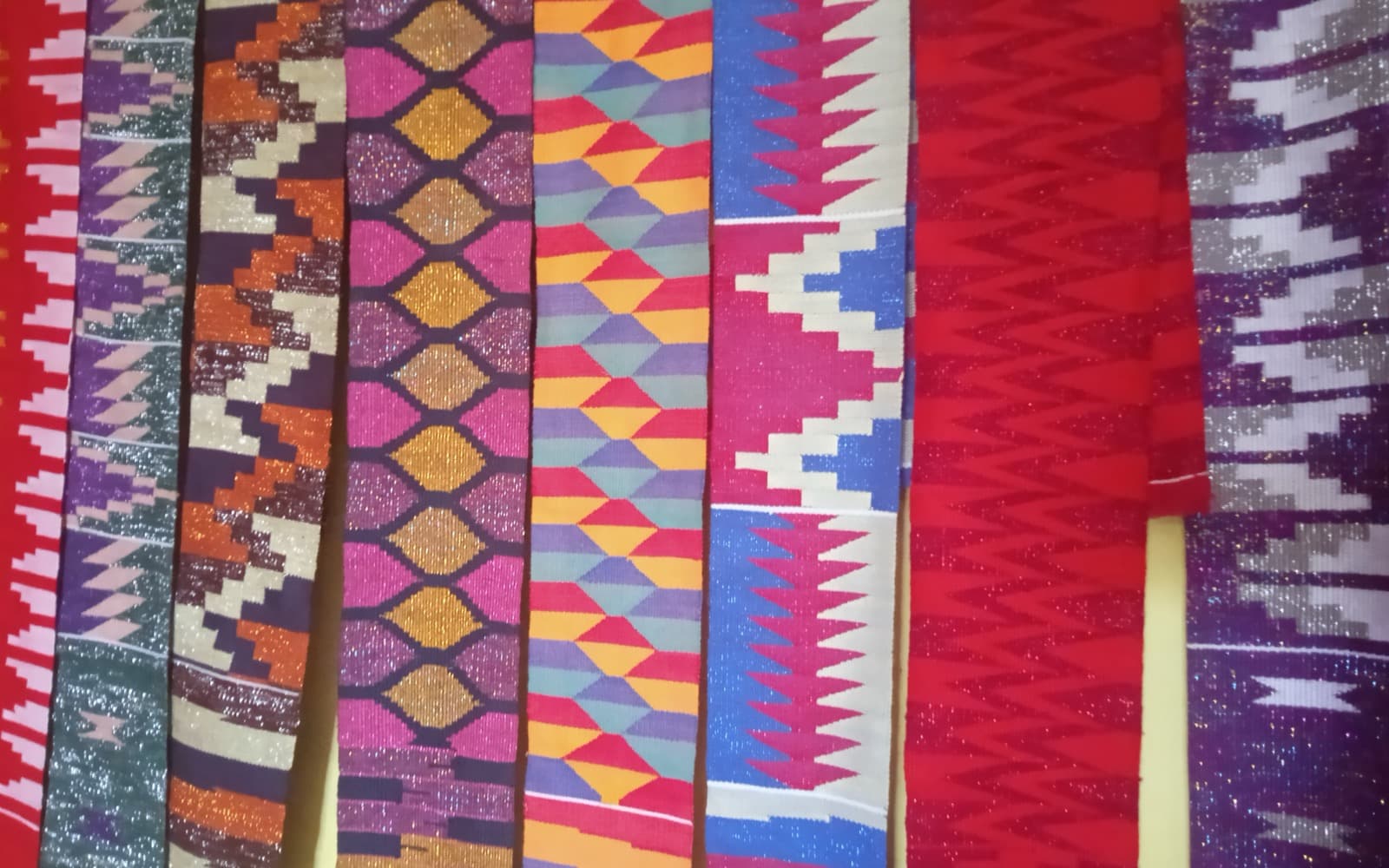 Colourful traditional kente garment strips in different designs from the Volta region