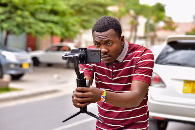 African content creator shooting with smartphone