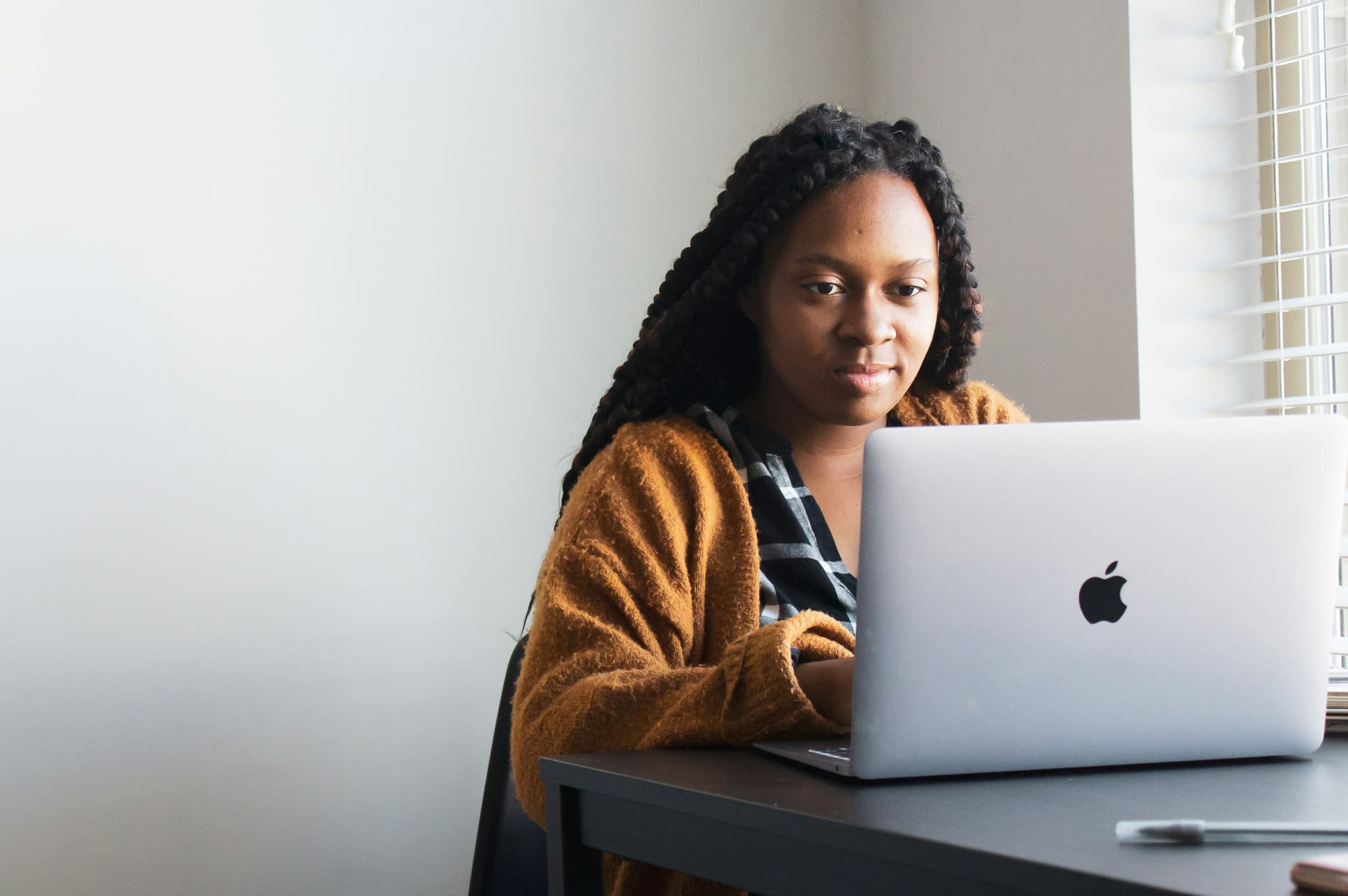 A creator working on her laptop