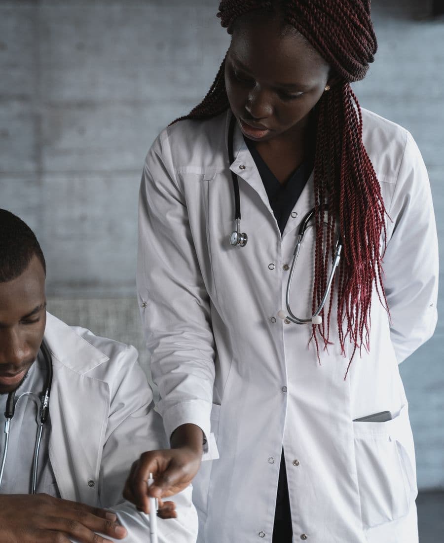Two doctors reviewing notes in a clinic