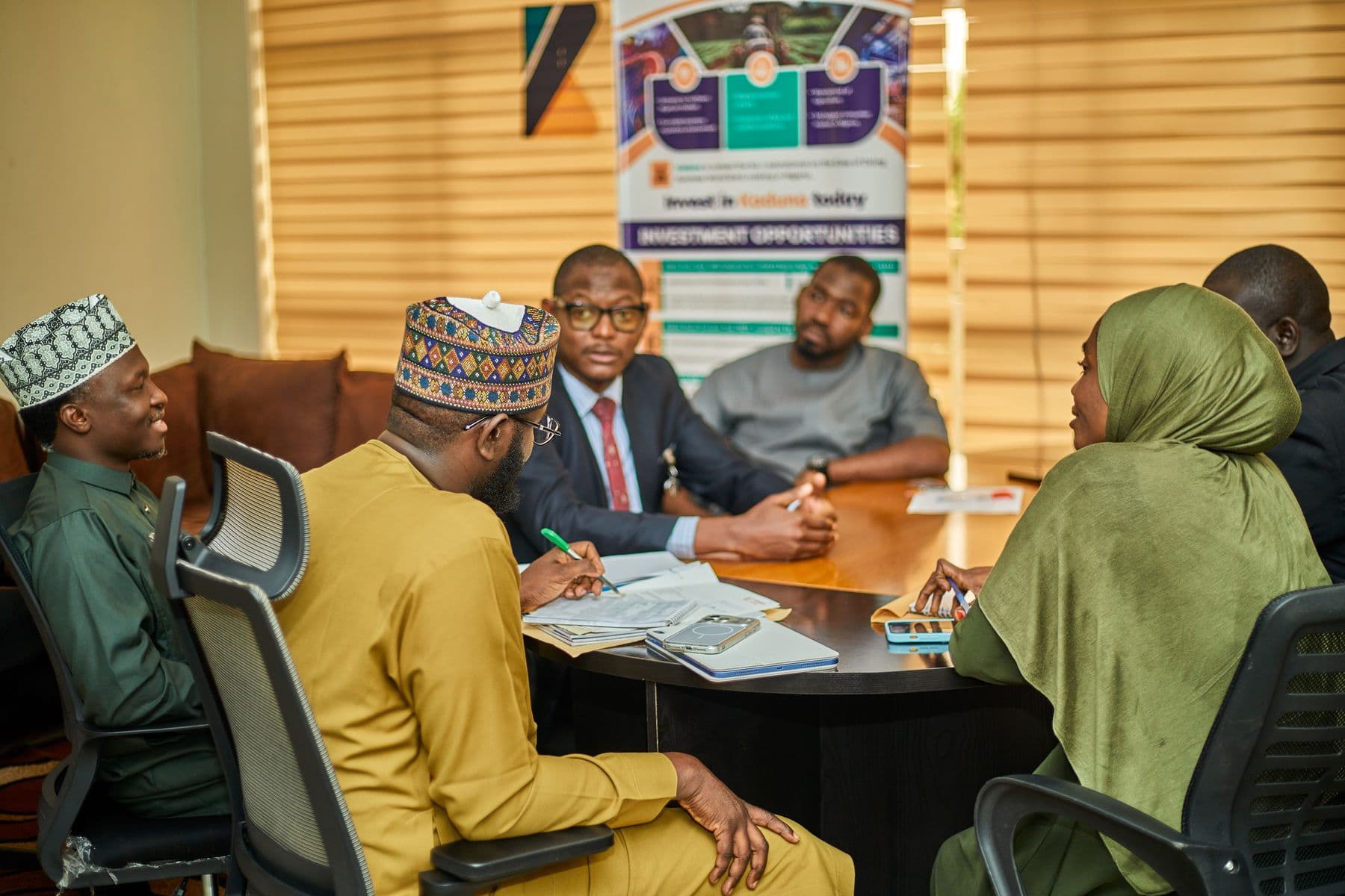 A corporate meeting in an African office, discussing campaign performance across markets